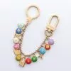 Pre-loved LOUIS VUITTON Porte Crescenne Pastille bag accessories Key Ring Gold Plated Gold multi